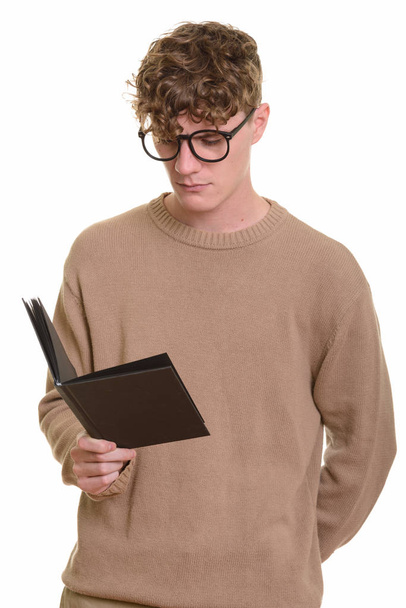 Young handsome Caucasian man reading book - Fotó, kép