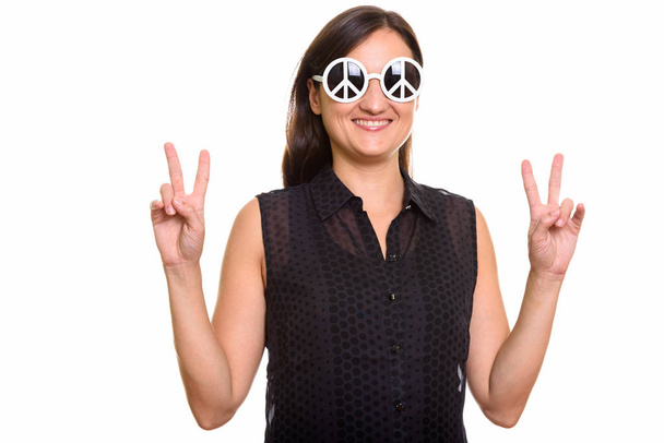 glücklich schöne Frau lächelt, während sie Sonnenbrille mit peac trägt - Foto, Bild