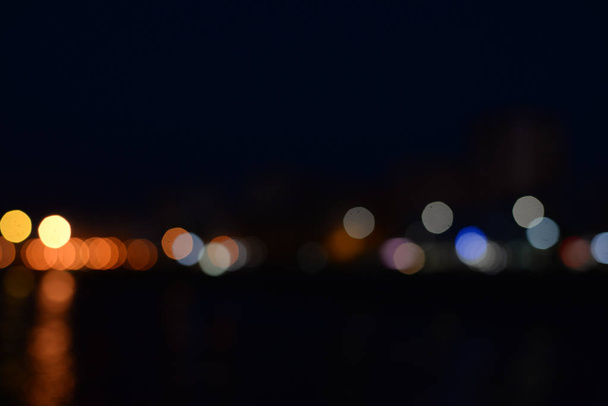 Blurred bokeh city light with reflection in the water background - Zdjęcie, obraz