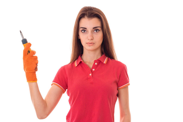 young girl holding a tool for repair of apartments with a serious face - Foto, immagini