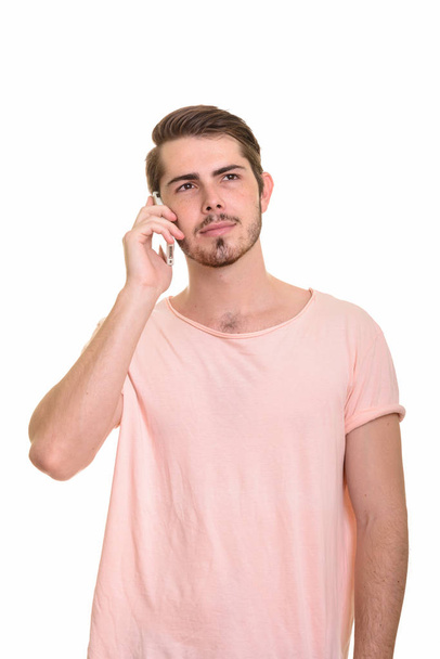 Young handsome Caucasian man talking on mobile phone - Fotoğraf, Görsel