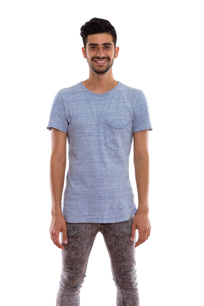 Studio shot of young happy Persian man smiling and standing - Foto, immagini