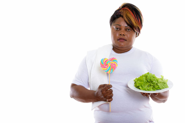 Studio shot of fat black African woman holding lettuce served on - Valokuva, kuva