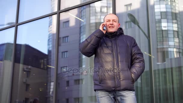 Man in the city making a phone call with smartphone - Кадри, відео