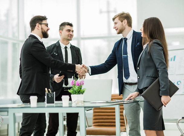 handshake of business partners after signing the contract in the workplace in a modern office - Photo, Image