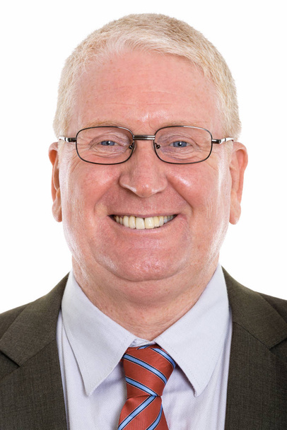 Face of happy mature businessman smiling while wearing eyeglasse - Fotó, kép