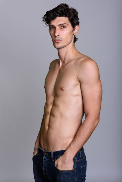 Studio shot of young handsome man shirtless - Фото, зображення