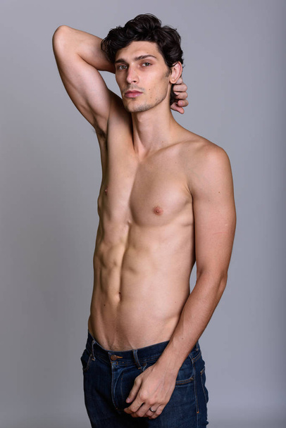 Studio shot of young handsome man posing shirtless - Фото, изображение