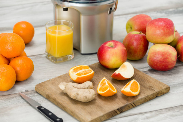 Modern electric juicer, various fruit and glass of freshly made juice, healthy lifestyle concept - Foto, Imagem