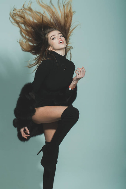 pretty sexy woman with long hair in fur and jackboot - Fotó, kép