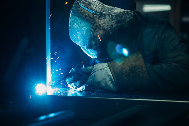 sparks while welder uses torch to welding - Photo, image
