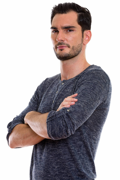 Studio shot of young handsome man with arms crossed - Foto, afbeelding