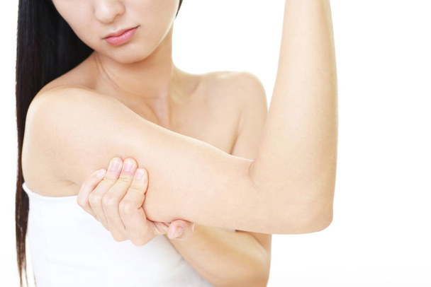 Woman checking her upper arm - Photo, Image