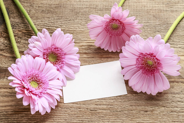 Pink gerbera flowers on wooden background - Foto, imagen