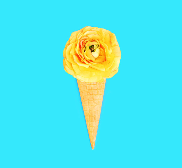 Ice cream cone with flowers over blue colorful background top vi - 写真・画像