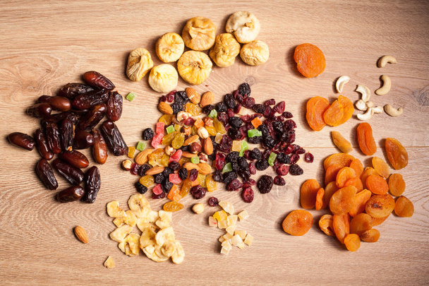 Dried fruits on wooden background - Photo, Image