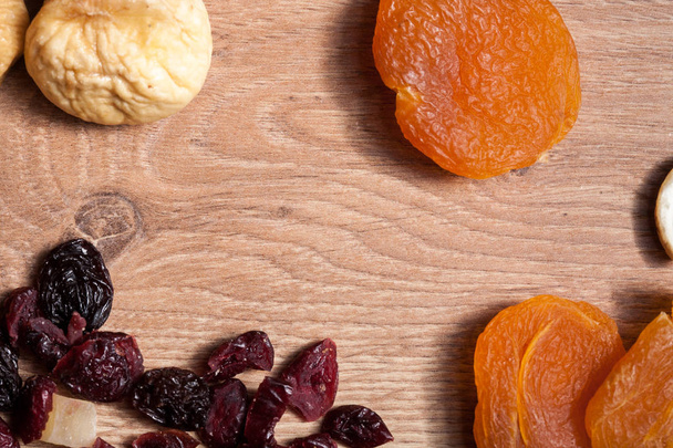 Different type of dried fruits on wooden background - Φωτογραφία, εικόνα