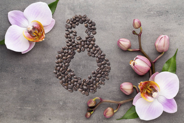 Coffee beans in form of number eight and orchids on beautifull background. International women's day. 8th march - Valokuva, kuva