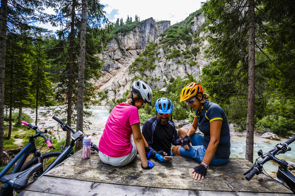 Family rides bikes in the mountains - Photo, Image