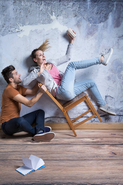 Terrified woman on toppling chair - Photo, Image