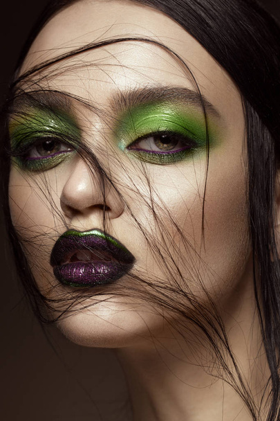 Beautiful girl with spring green makeup and vampire lips. beauty face. - Foto, afbeelding