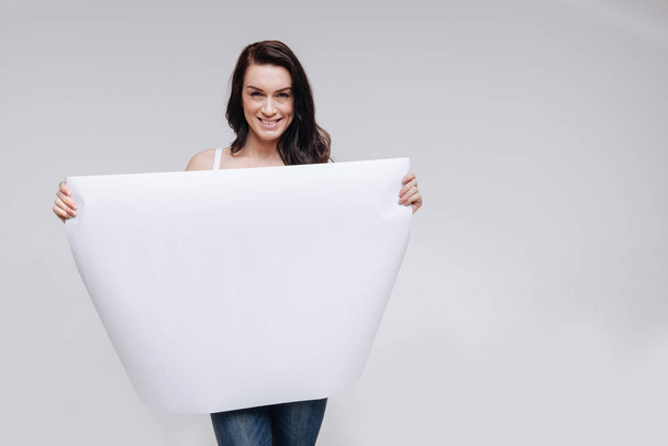 lady showing a big blank sheet of paper - Foto, Imagen