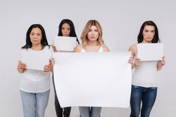 ladies demonstrating a big blank poster  - 写真・画像