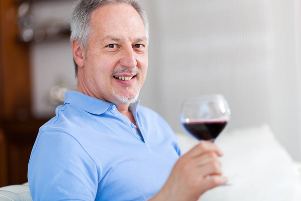mature man enjoying glass of wine  - Zdjęcie, obraz