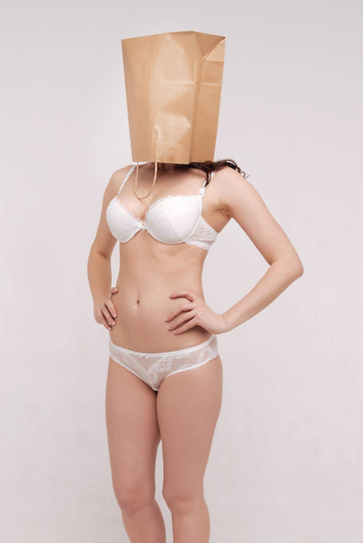 woman covering her face with a paper bag - Fotó, kép