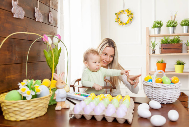 Easter concept. Happy mother and her cute child getting ready for Easter  - Foto, immagini