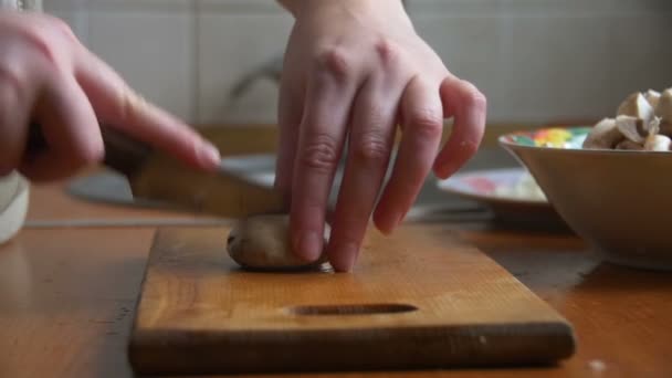 Slicing mushrooms on a kitchen board - Footage, Video