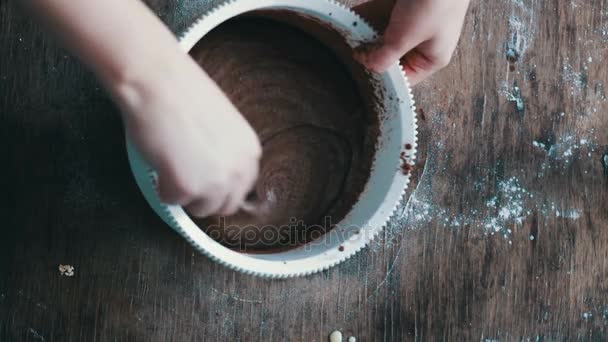 Widok z góry mieszając ciastko czekoladowe ciasto łyżką w misce biały z tworzywa sztucznego - Materiał filmowy, wideo