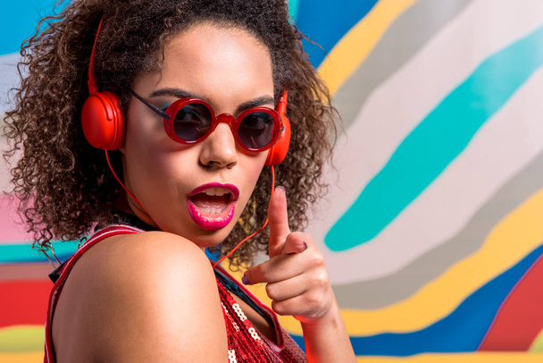 Outgoing female hearing music thorough headset - Foto, immagini