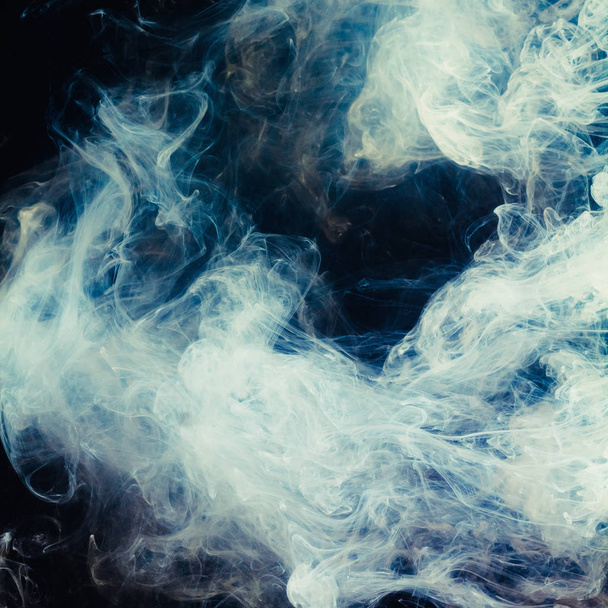 Abstract pattern of white smoke on a black background. Waves of mist and clouds. - Foto, Bild