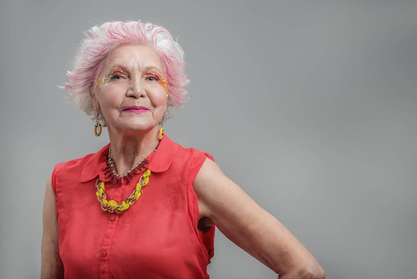 Smiling senior woman with fashionable hairstyle - 写真・画像