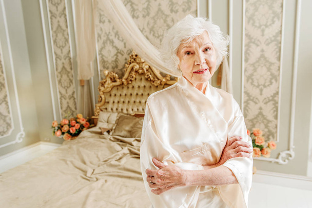 Elegant senior lady resting in bedroom - Foto, imagen