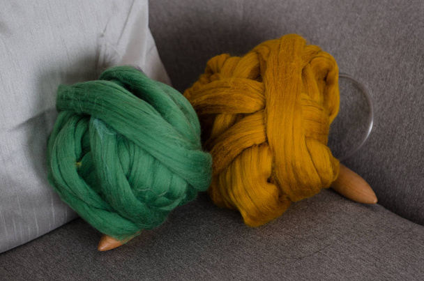 Green and brown merino wool on arm chair - Фото, зображення