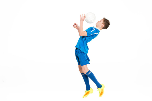 Young boy with soccer ball doing flying kick - Fotografie, Obrázek