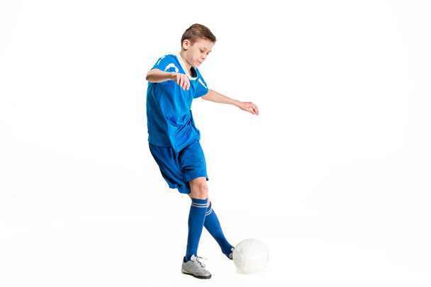 Young boy with soccer ball doing flying kick - Fotoğraf, Görsel
