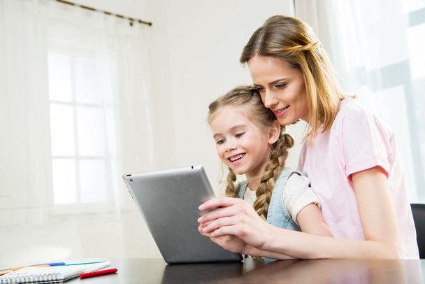 mother and daughter using digital tablet - Photo, Image