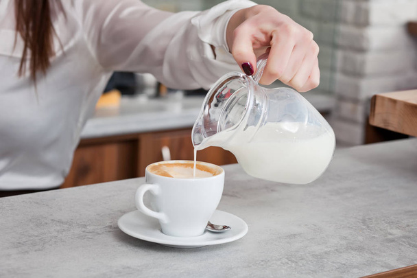cup of coffee with milk on the table - 写真・画像