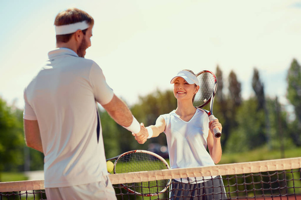 Shaking hands after tennis training - Photo, image