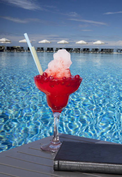 red cocktail at the pool  - Fotoğraf, Görsel