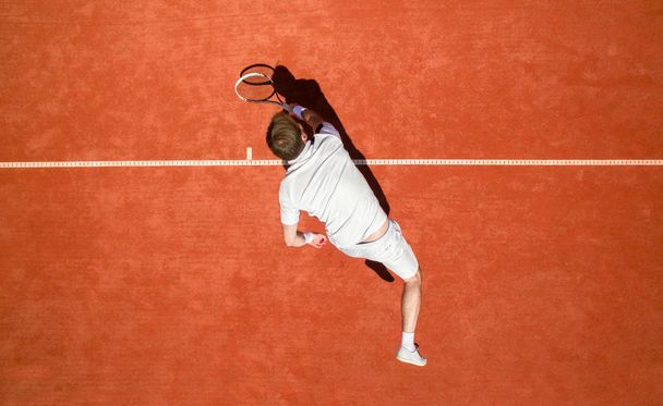 Top view of tennis player hitting ball - Fotografie, Obrázek