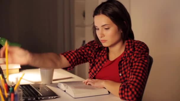 student girl or woman reading book at night home - Video