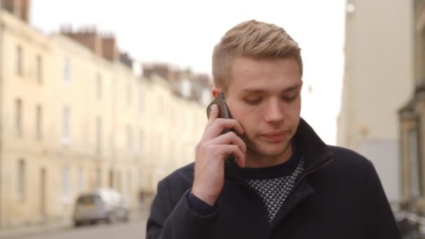 Young Man Talking On Mobile Phone  - Materiał filmowy, wideo
