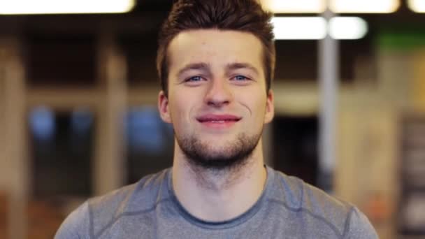 happy smiling young man at gym - Záběry, video