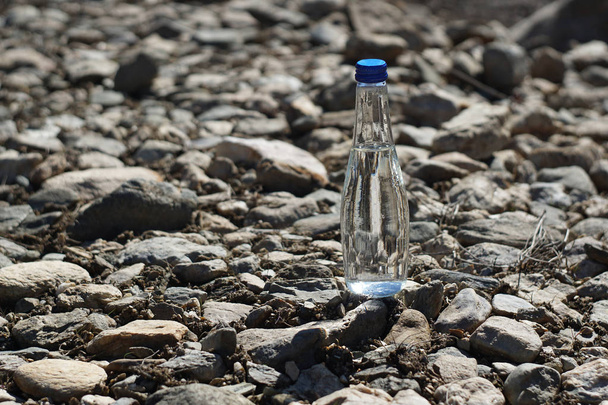 Water bottle on a stone background - Valokuva, kuva