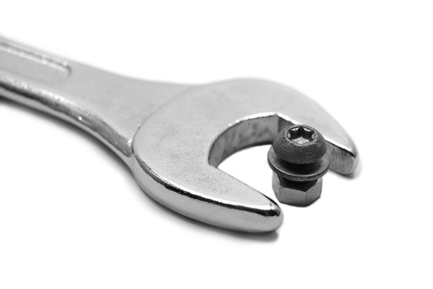 Wrong tool: big wrench with little nut and screw - Photo, Image
