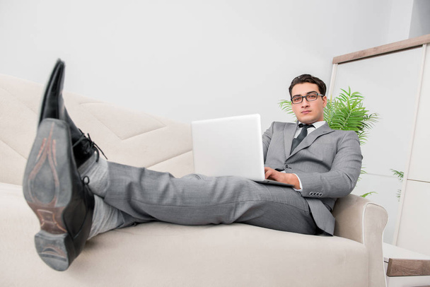 Young businessman lying on the sofa - Foto, Imagen